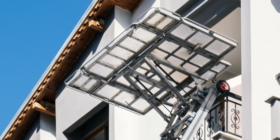 Furniture lift in use transporting furniture to a balcony. Movers. Barrier-free access.