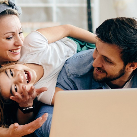 Glückliche Familie mit Kartons & Kind