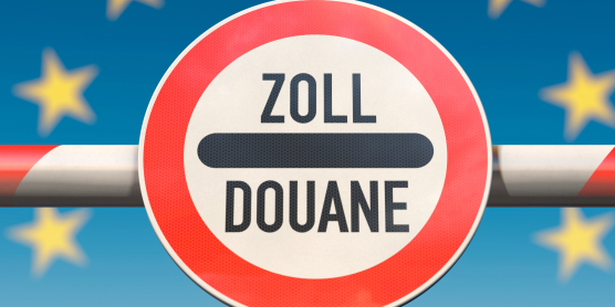 Zoll-Schild an einer geschlossenen Schranke vor EU-Sternen – Symbol für Grenzkontrolle und Zollbestimmungen